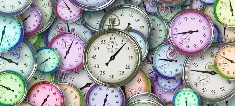 A close-up of a pile of pocket watches.