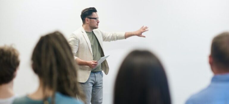 A trainer giving a lecture in front of a group.