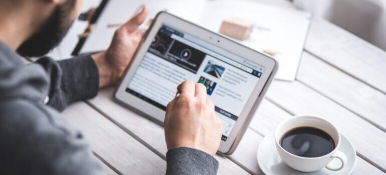 An employee looking at CRM lessons online via tablet.