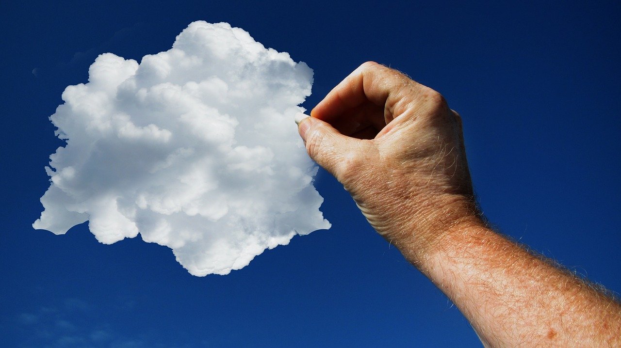 Hand grabbing cloud from a blue sky - Upsides of Cloud-based CRM software