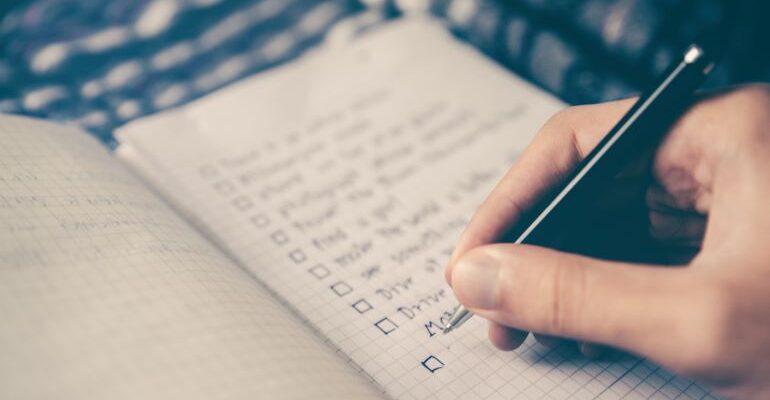 Person writing an improvement checklist