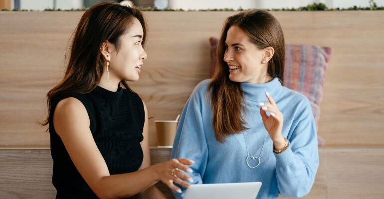 Two women discussing customer experience.