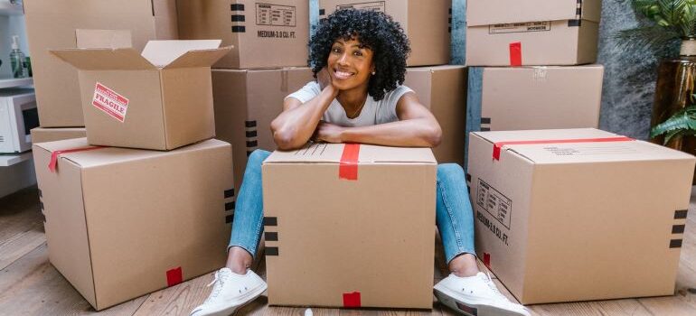 Woman sitting around boxes ready to move.
