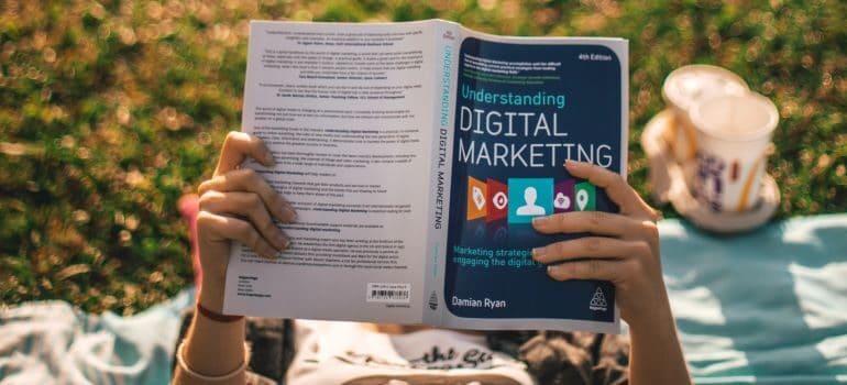 A person reading a book about digital marketing.