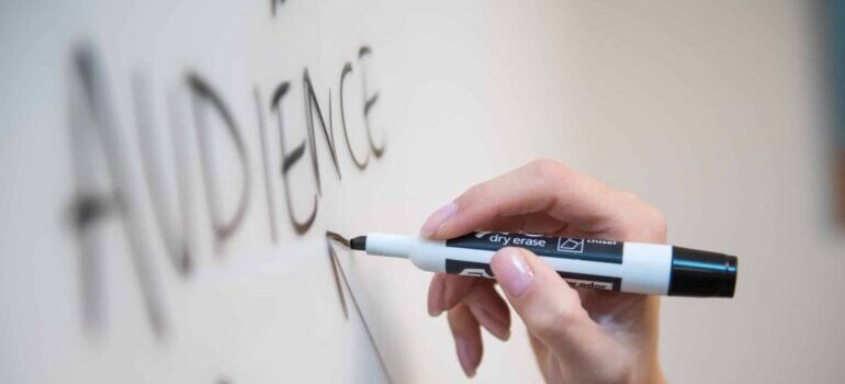 A person writing on a whiteboard.