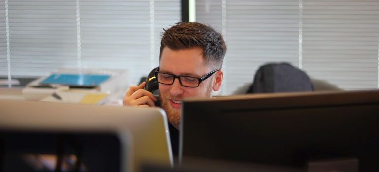 a man speaking on the phone in the office