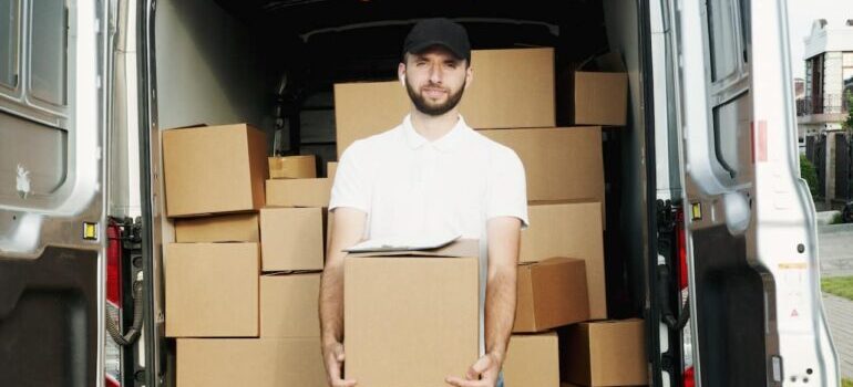 A mover holding moving boxes.