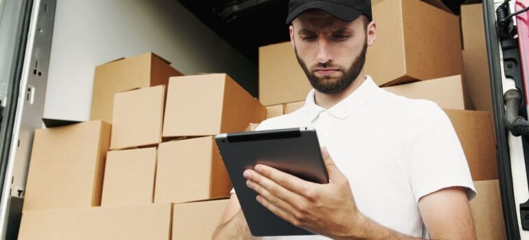 A mover looking at customer data on a tablet PC.