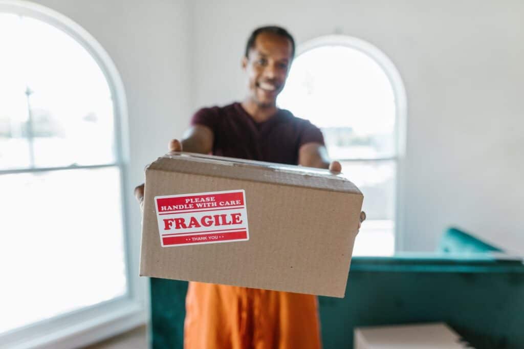 A man carrying a box labeled "fragile".