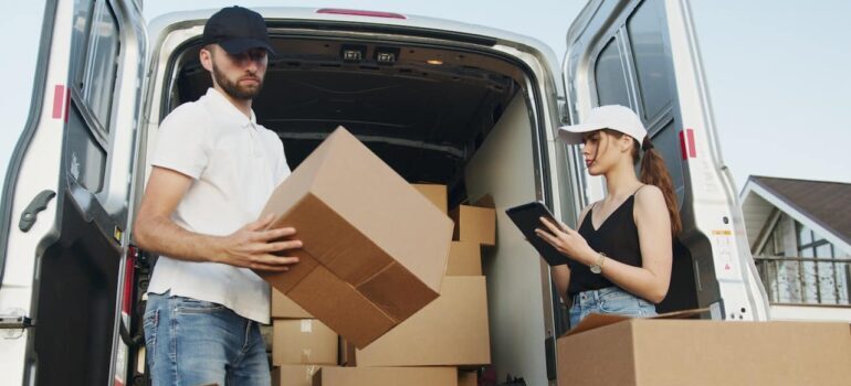 two movers packing up a van