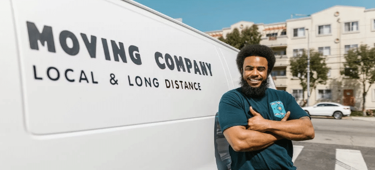 A man standing next to a moving van