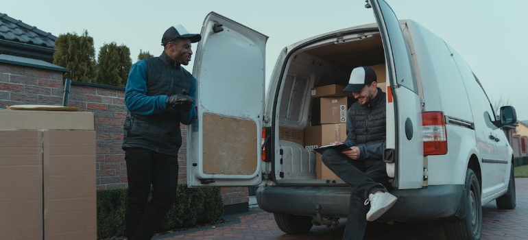 Two moving workers talking to each other