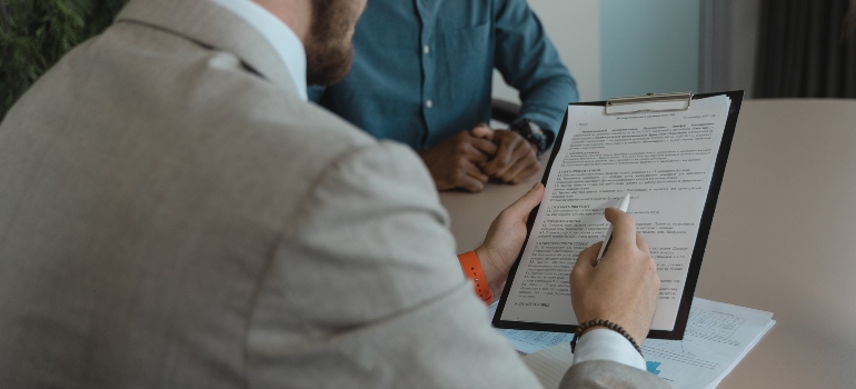 Two men at a table discussing feedback they received