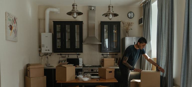 A man packing boxes in a room