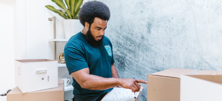 A man checking items after looking how to maximize off season productivity with moving CRM
