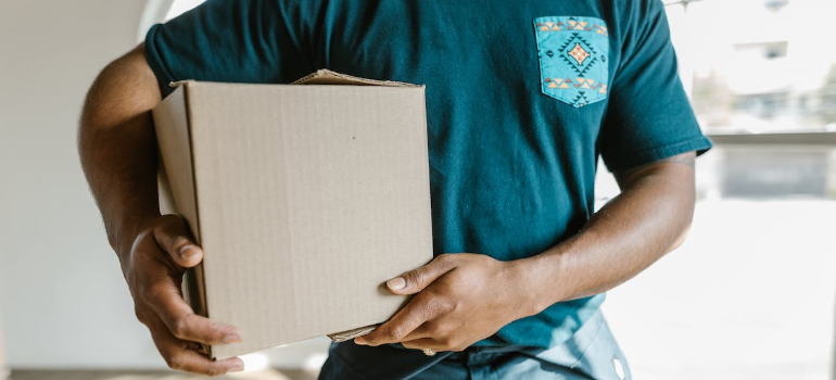 A worker holding a cardboard box
