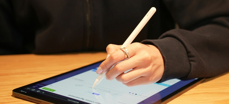 Person writing an e-signature on a tablet 