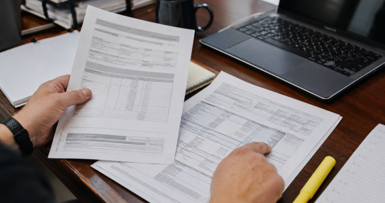 moving company estimate and bill of lading being checked for FMCSA compliance